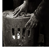 miner's hands reaching towards warm fir for heat- Taff Merthyr Colliery, 1992